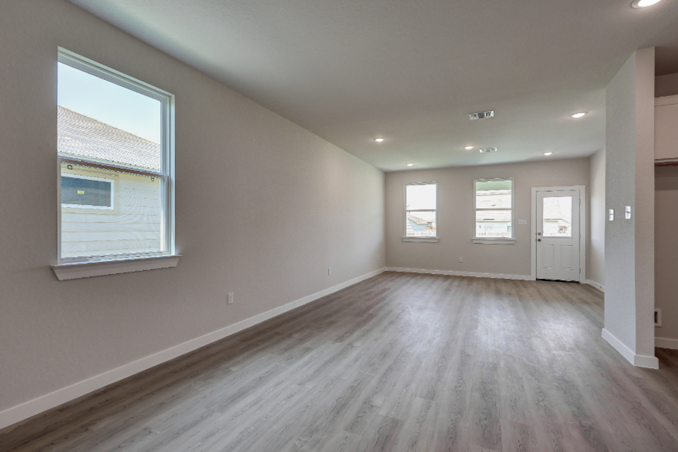 A room with a wood floor and white walls.