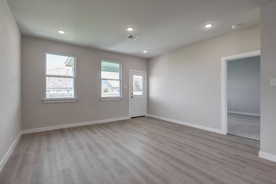 A room with a wood floor and white walls.