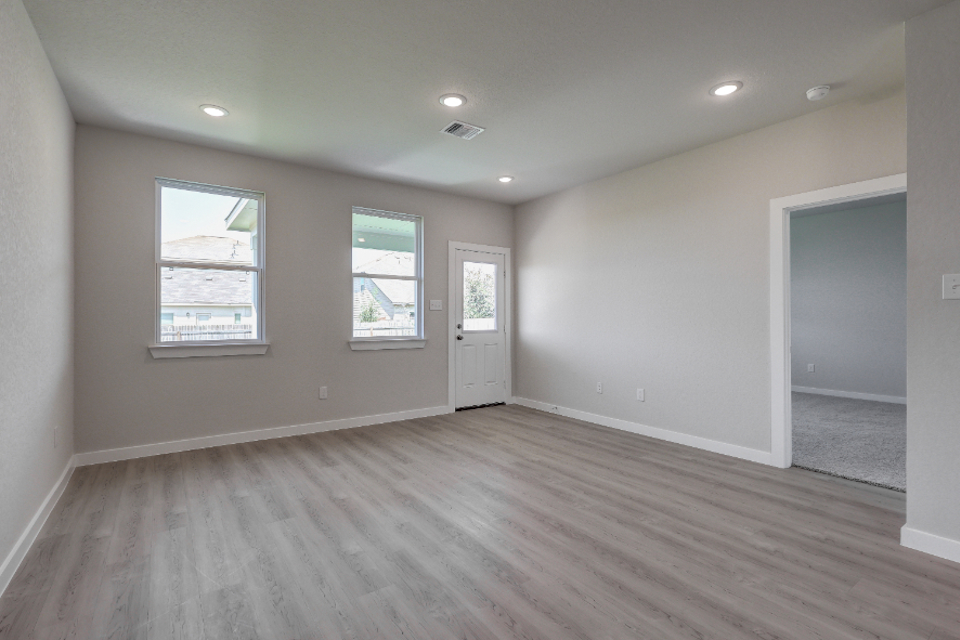 A room with a wood floor and white walls.