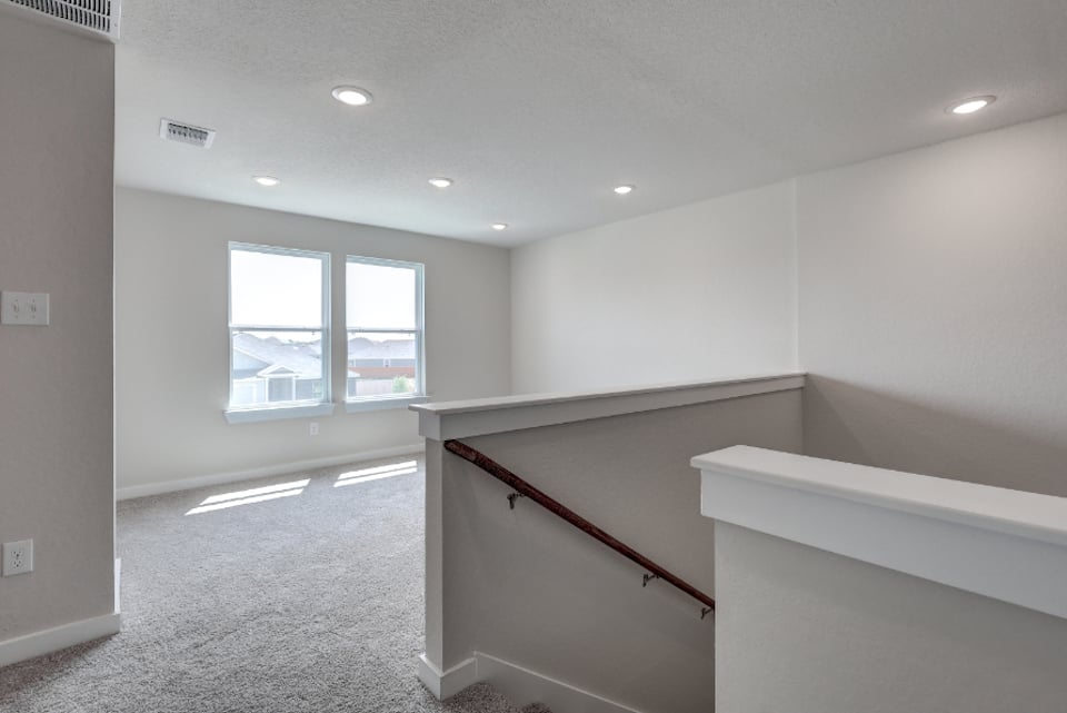A room with a staircase and a window.