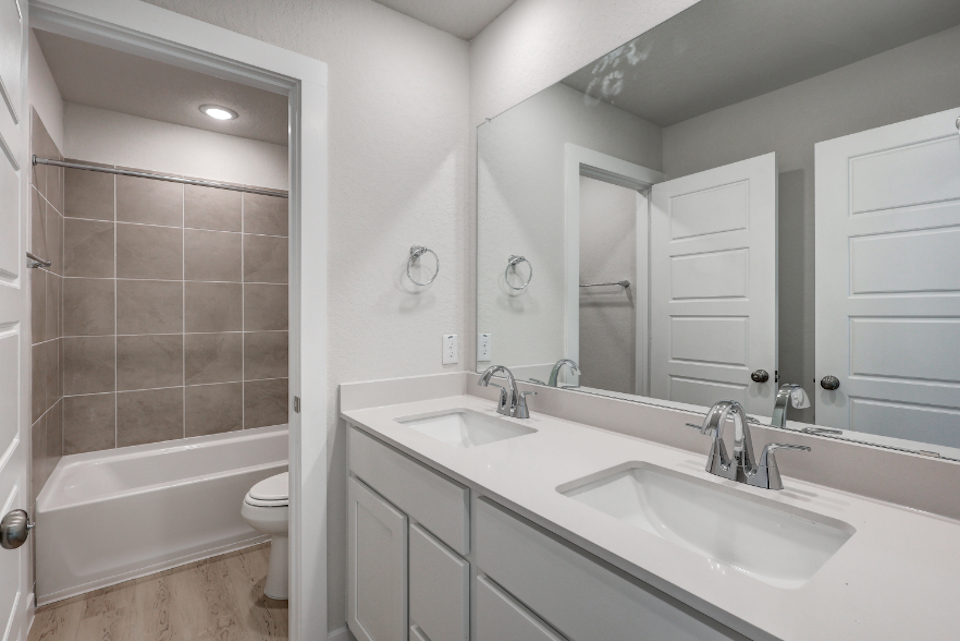 A bathroom with a tub sink and toilet.