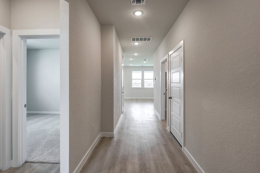 A hallway with white doors.