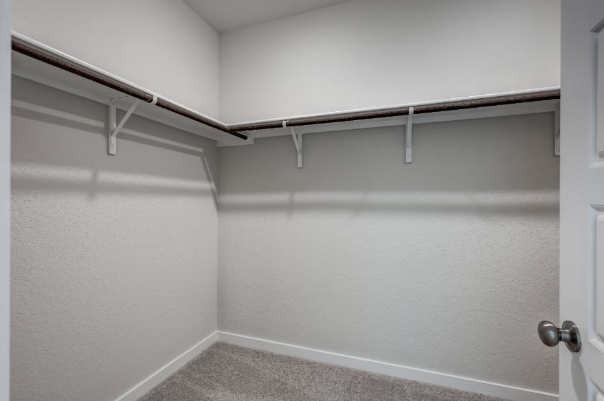 A white wall with a metal railing.