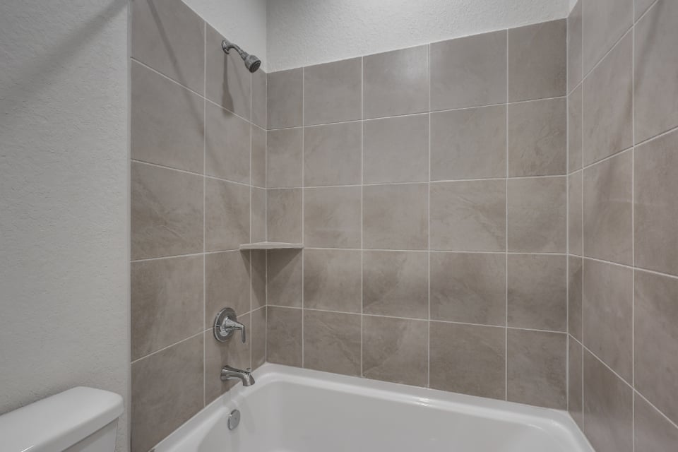 A bathtub in a bathroom.