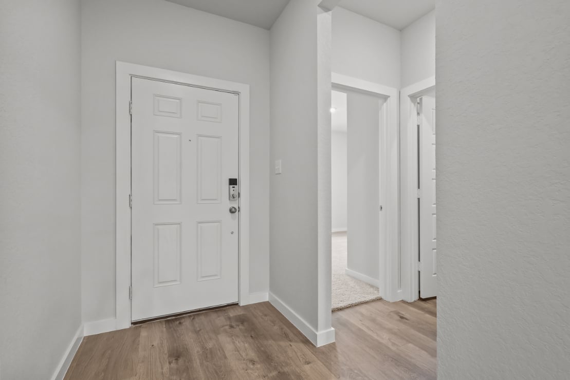 A hallway with white doors.