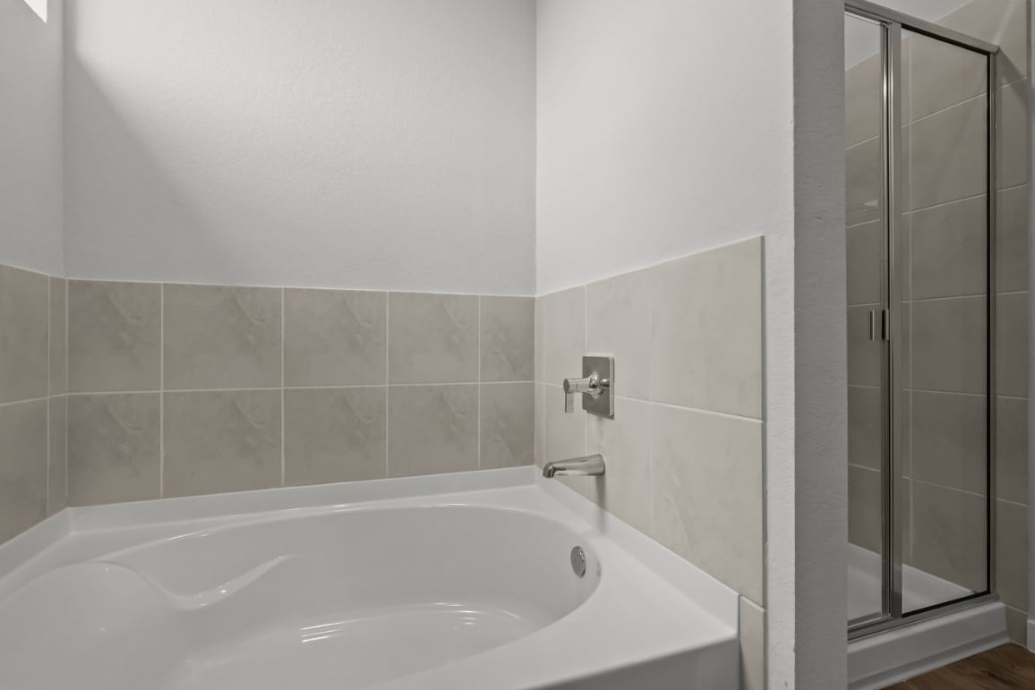 A bathtub in a bathroom.