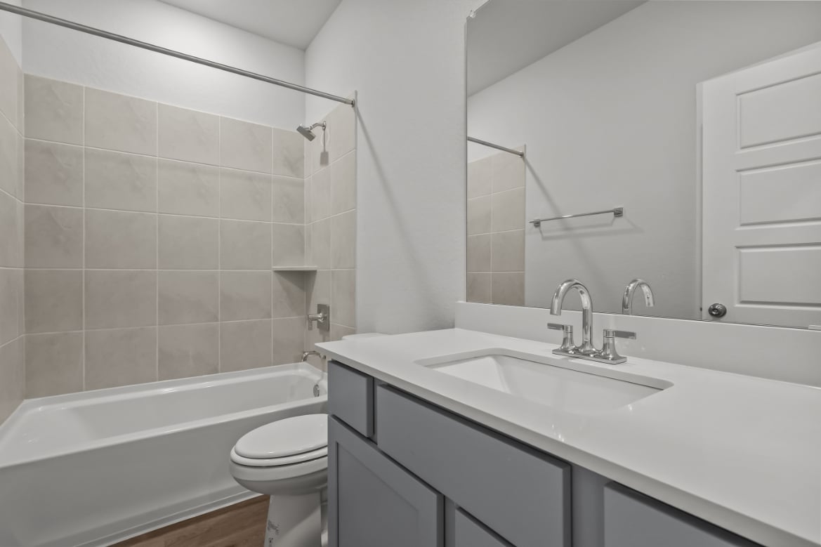 A bathroom with a sink toilet and bathtub.