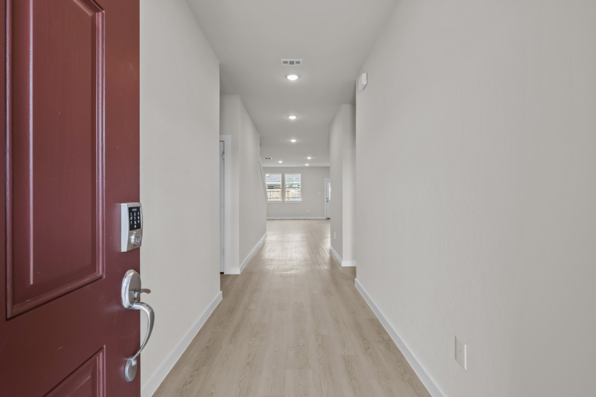 A hallway with red doors.