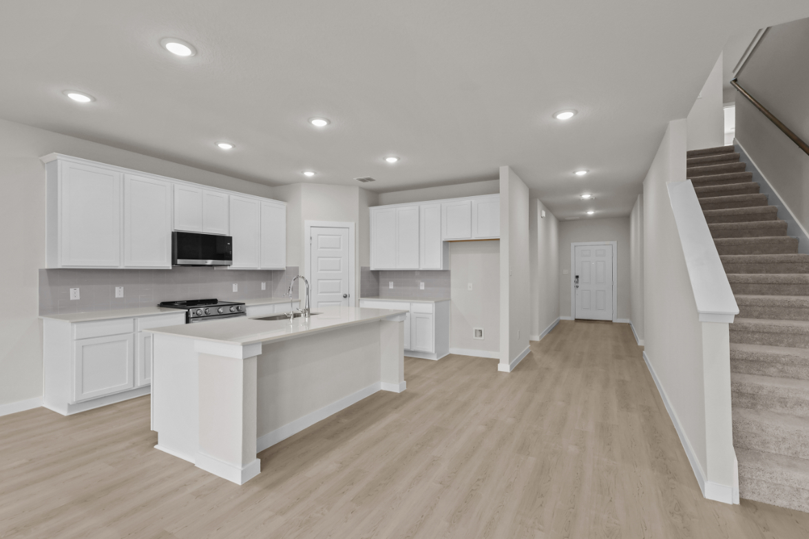 A kitchen with white cabinets.