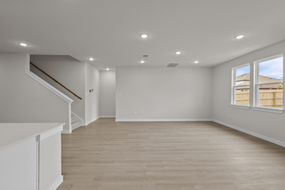 A room with white walls and a wood floor.