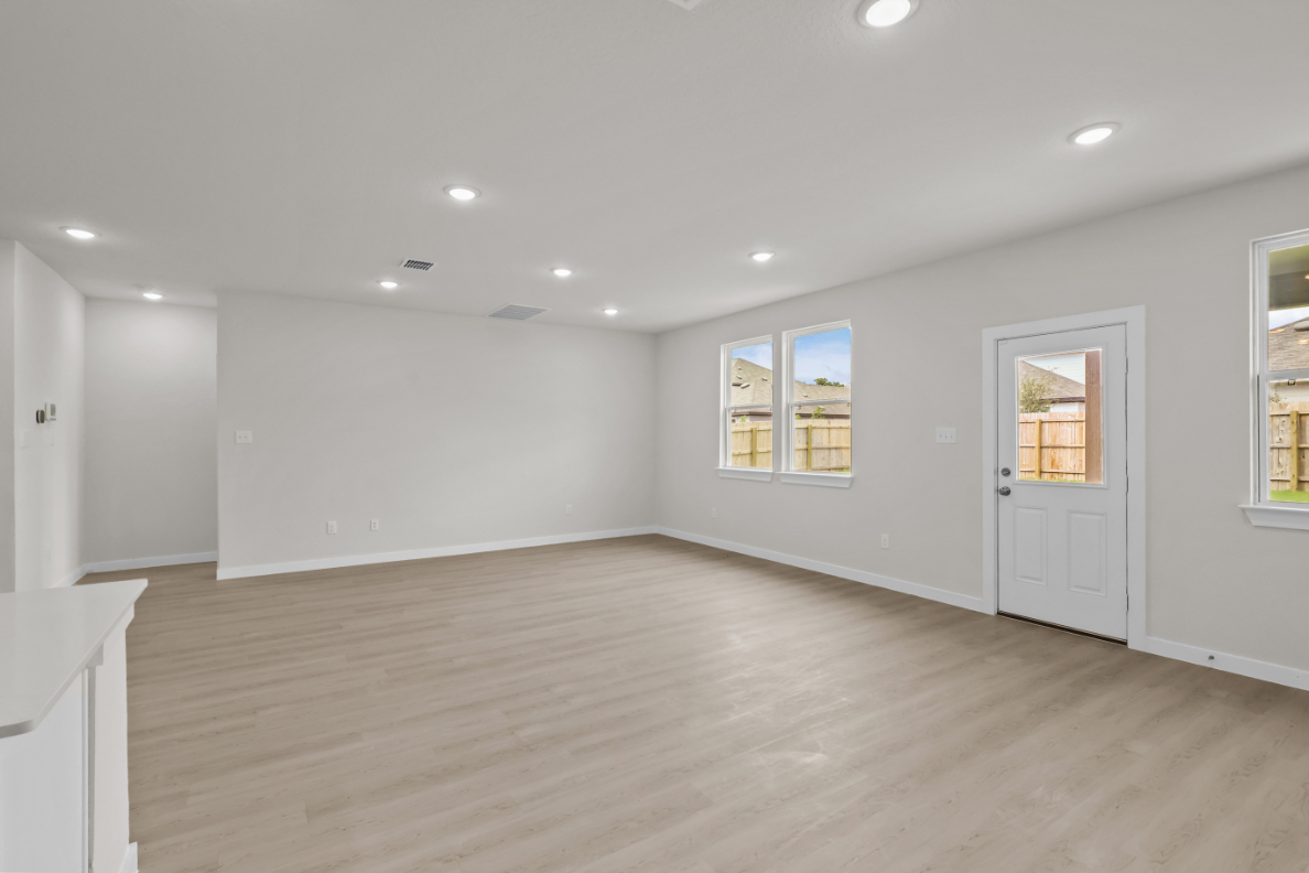 A room with white walls and a wood floor.