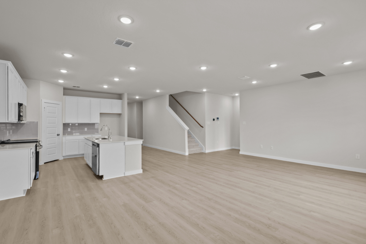 A large kitchen with white cabinets.