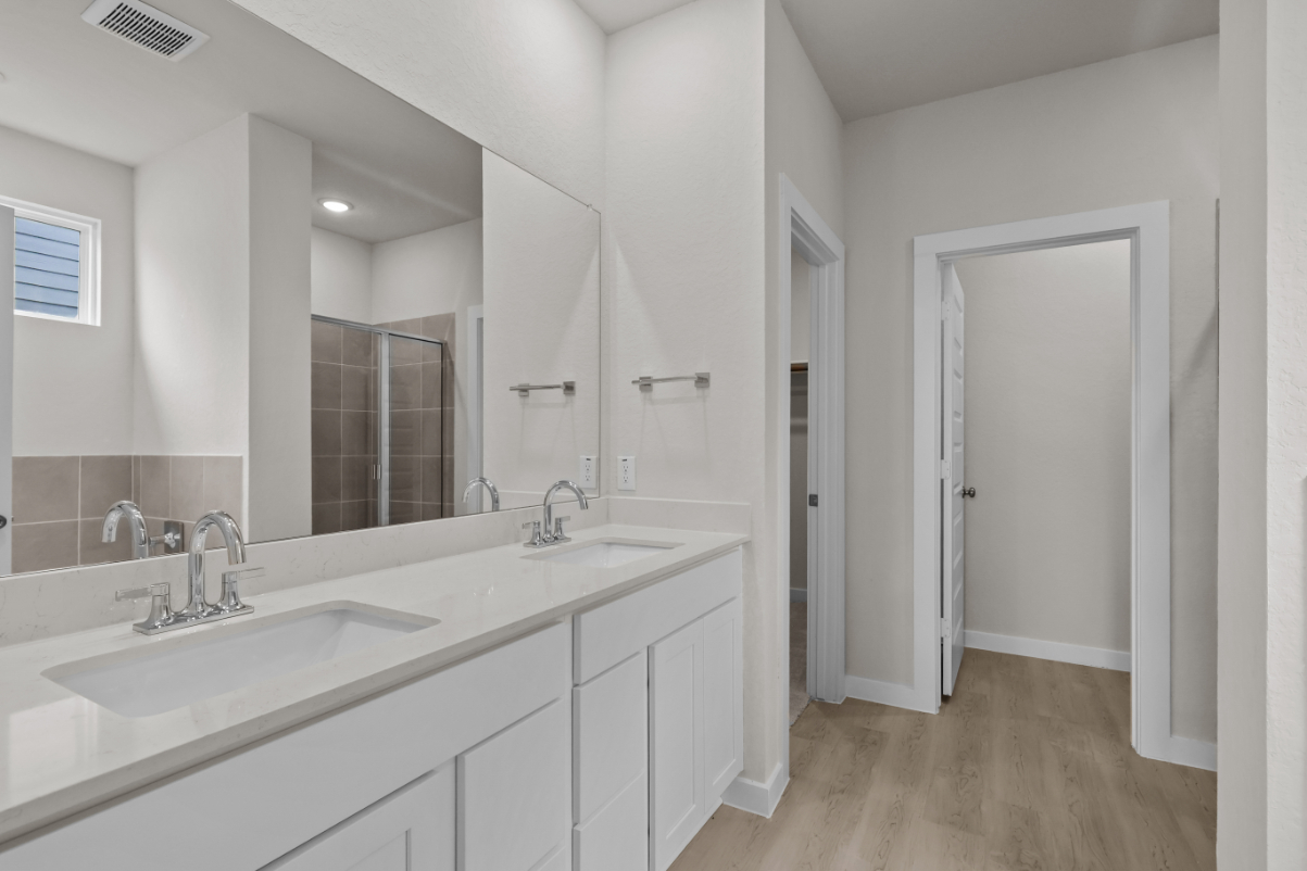 A bathroom with a large mirror.
