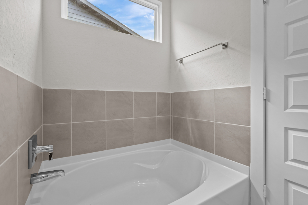 A bathtub in a bathroom.