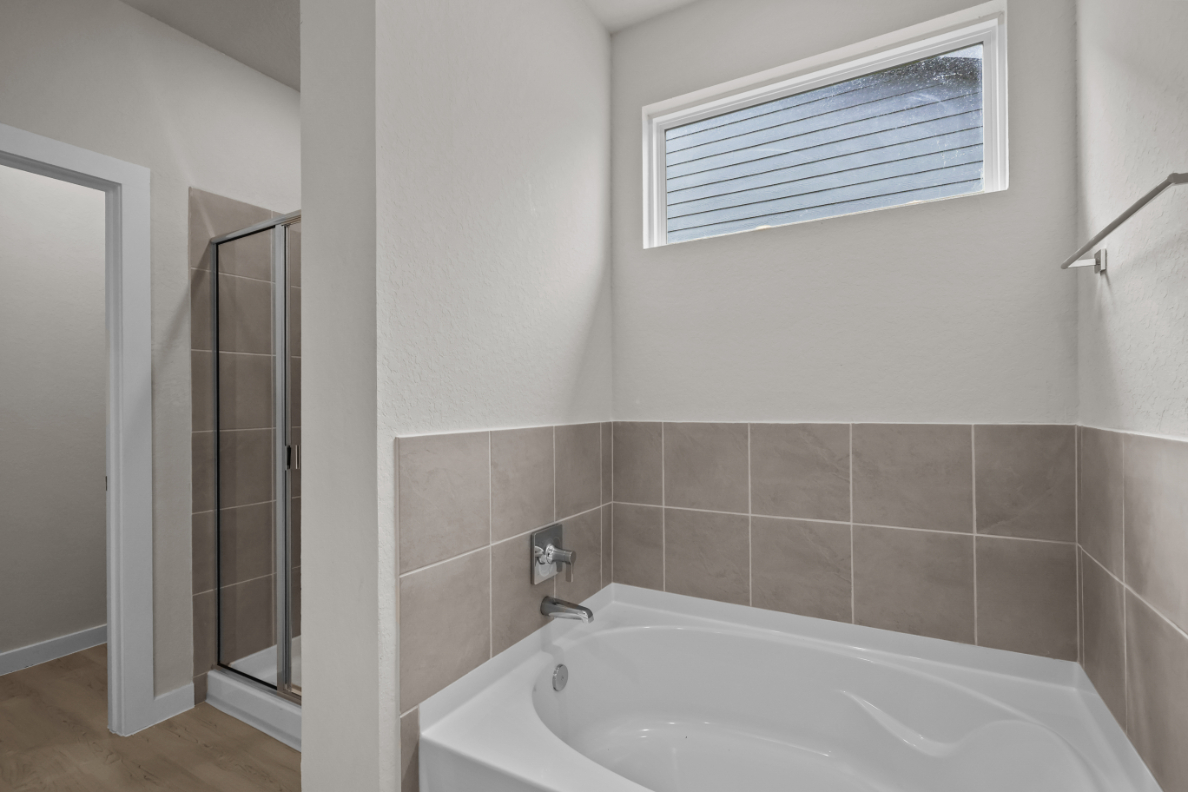 A bathroom with a tub and shower.