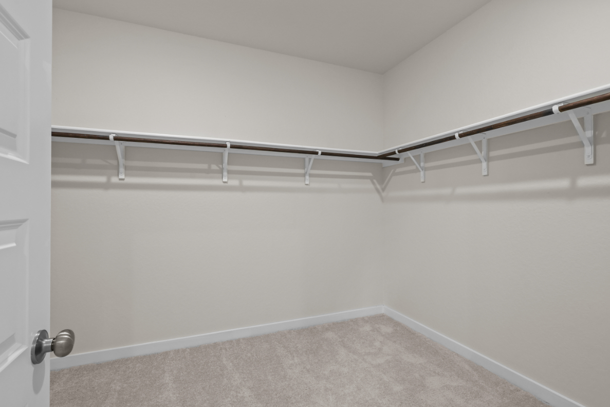 A white wall with a metal railing.