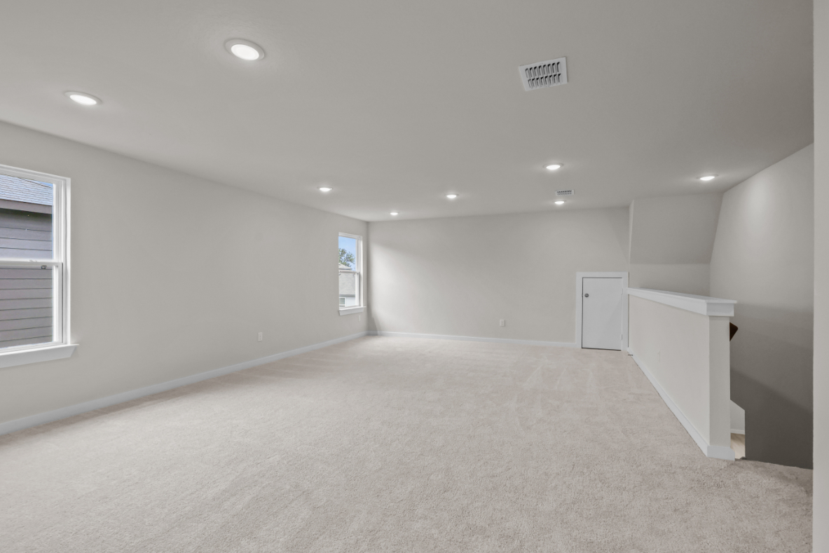 A room with a white carpet and a white wall.