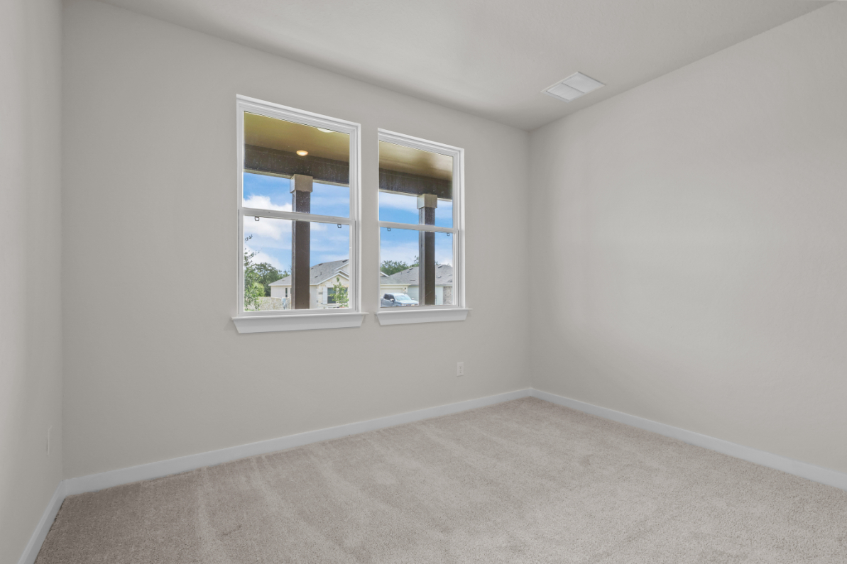 A room with a window and a white wall with a white floor.