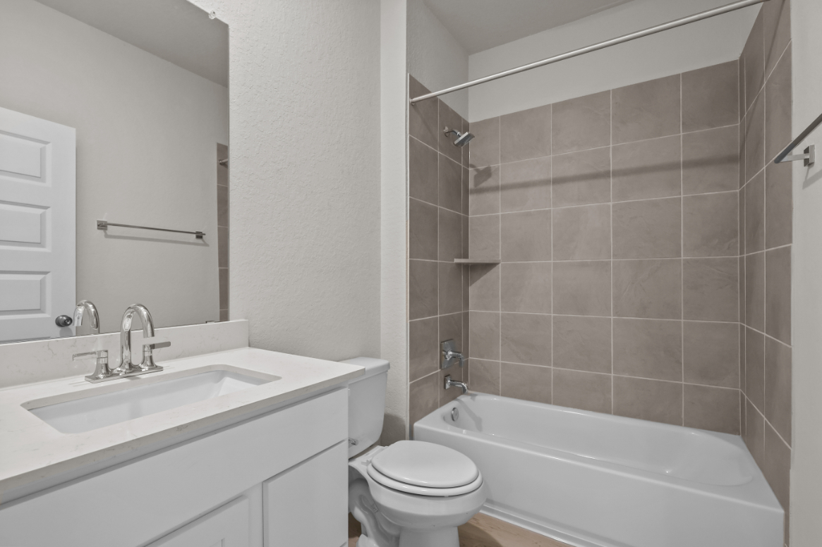 A bathroom with a sink toilet and bathtub.
