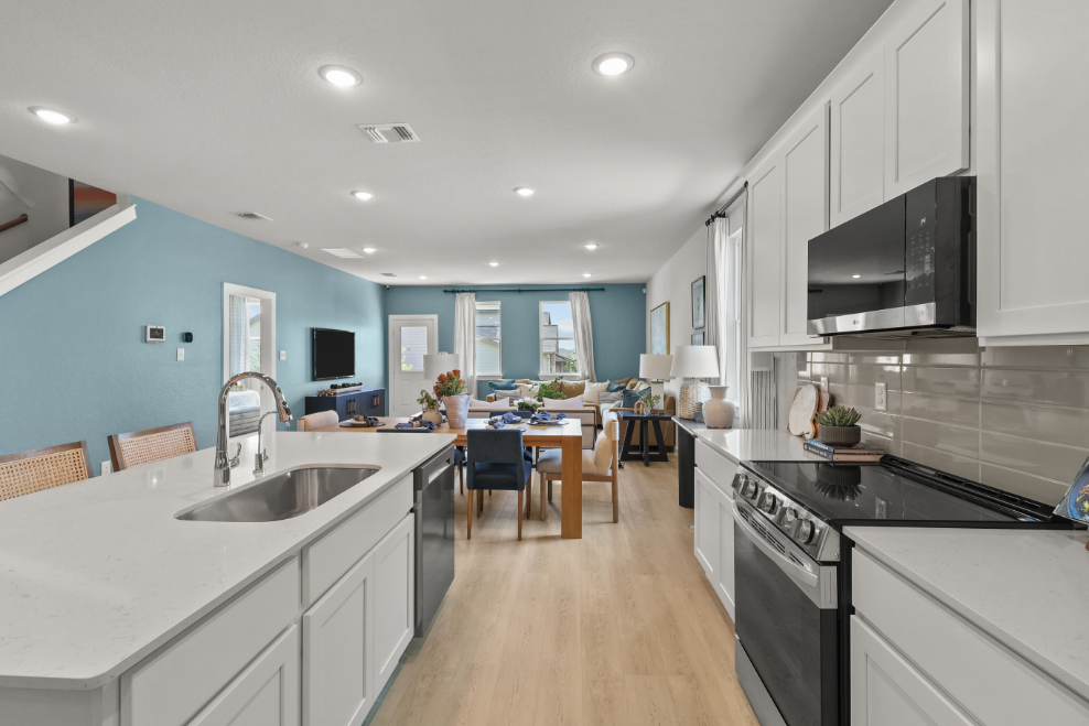 A kitchen with a table and chairs.