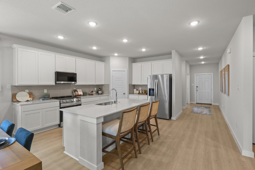 A kitchen with white cabinets.
