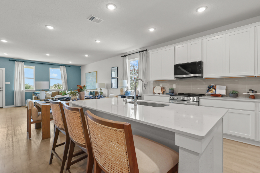 A kitchen with white cabinets.
