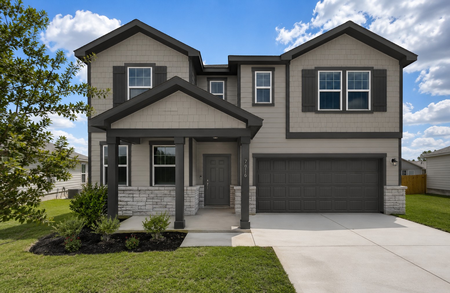A grey house with a garage.