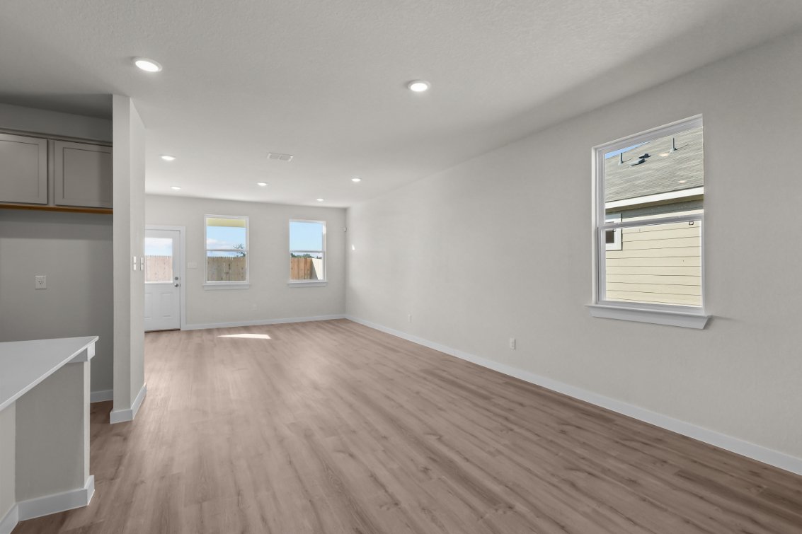 A room with white walls and a wood floor.