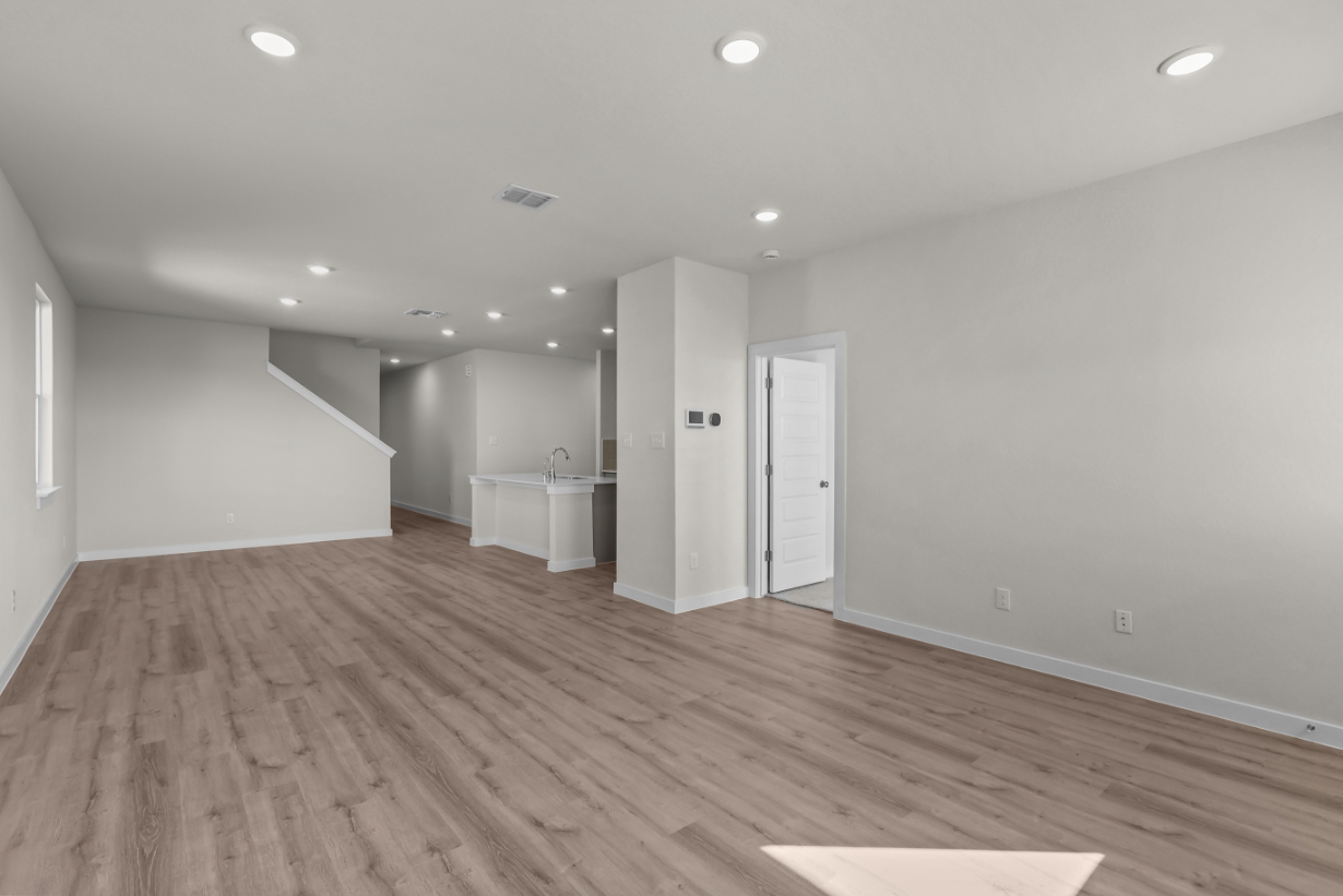 A room with a wood floor and white walls.