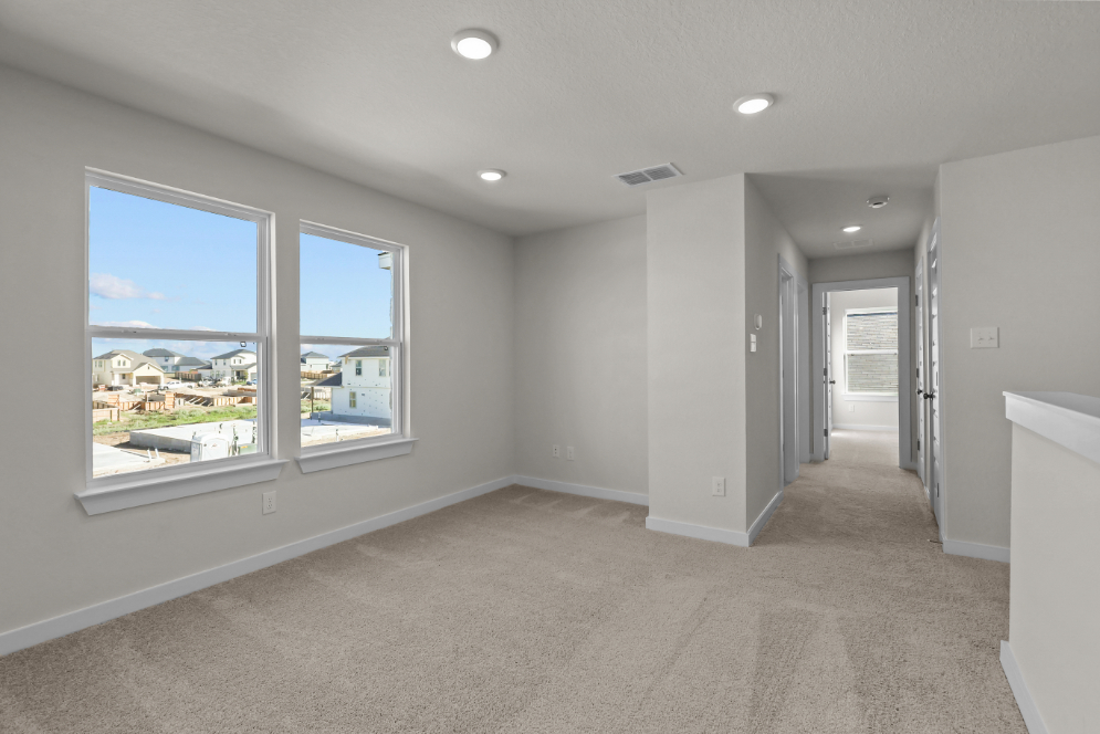 A room with a window and a view of the city.