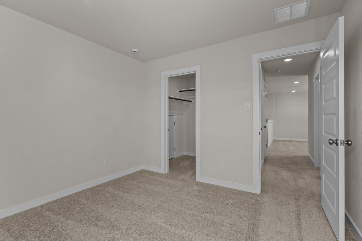 A hallway with white walls.