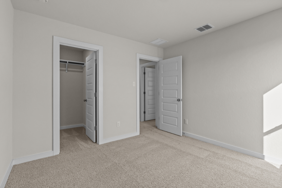 A room with white cabinets.