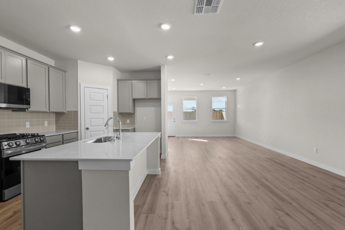 A kitchen with white cabinets.