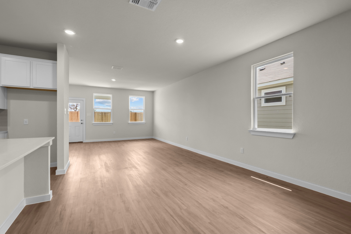 A room with white walls and a wood floor.