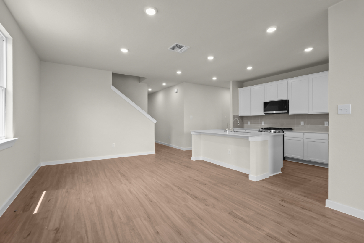 A kitchen with white cabinets.