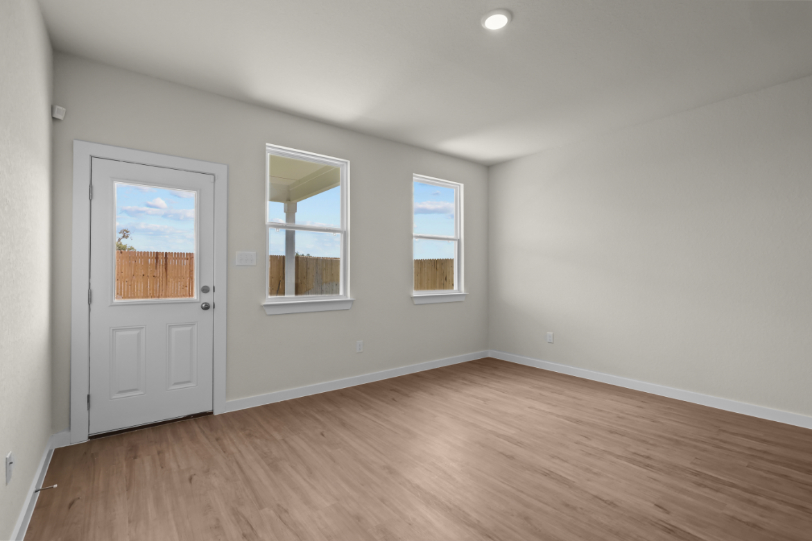 A room with a wood floor and a white door.