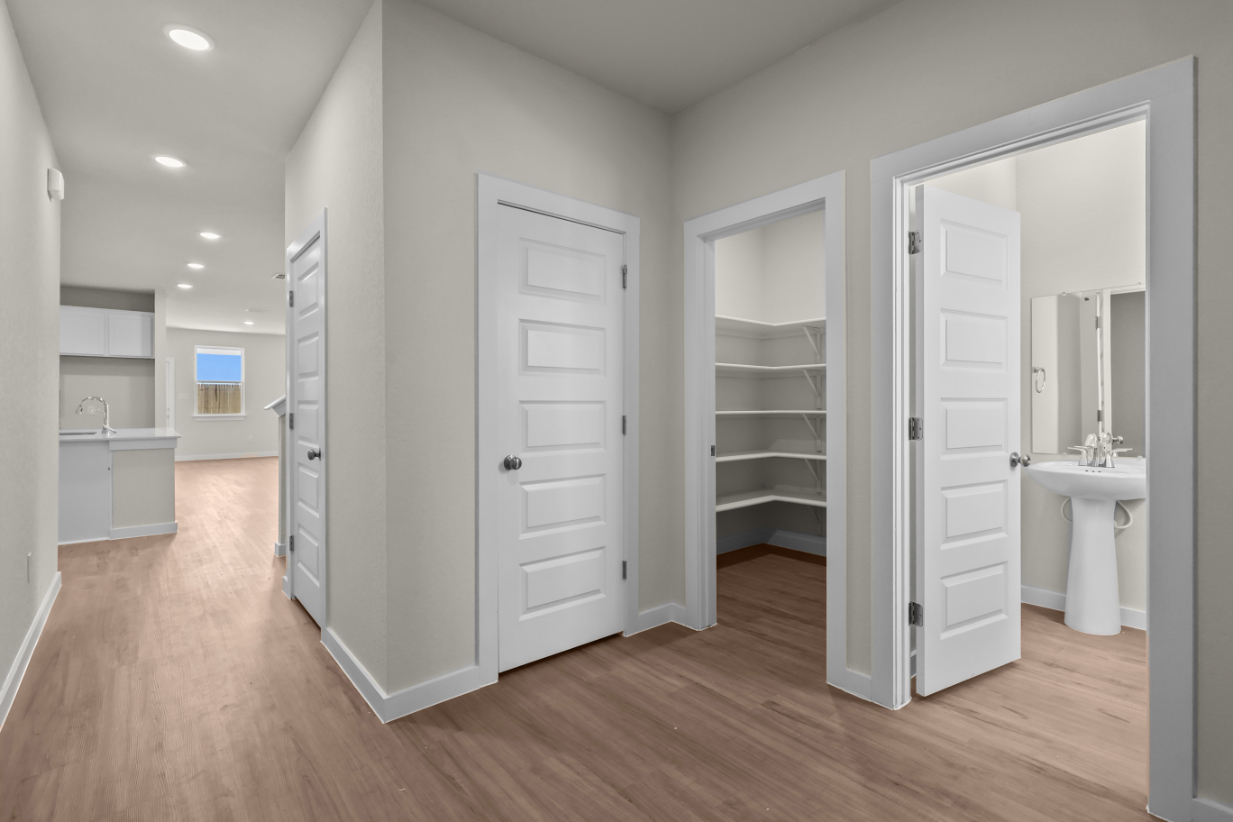 A bathroom with white cabinets.