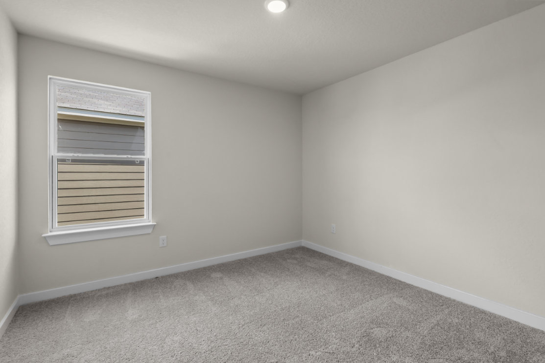 A room with a window and carpet.