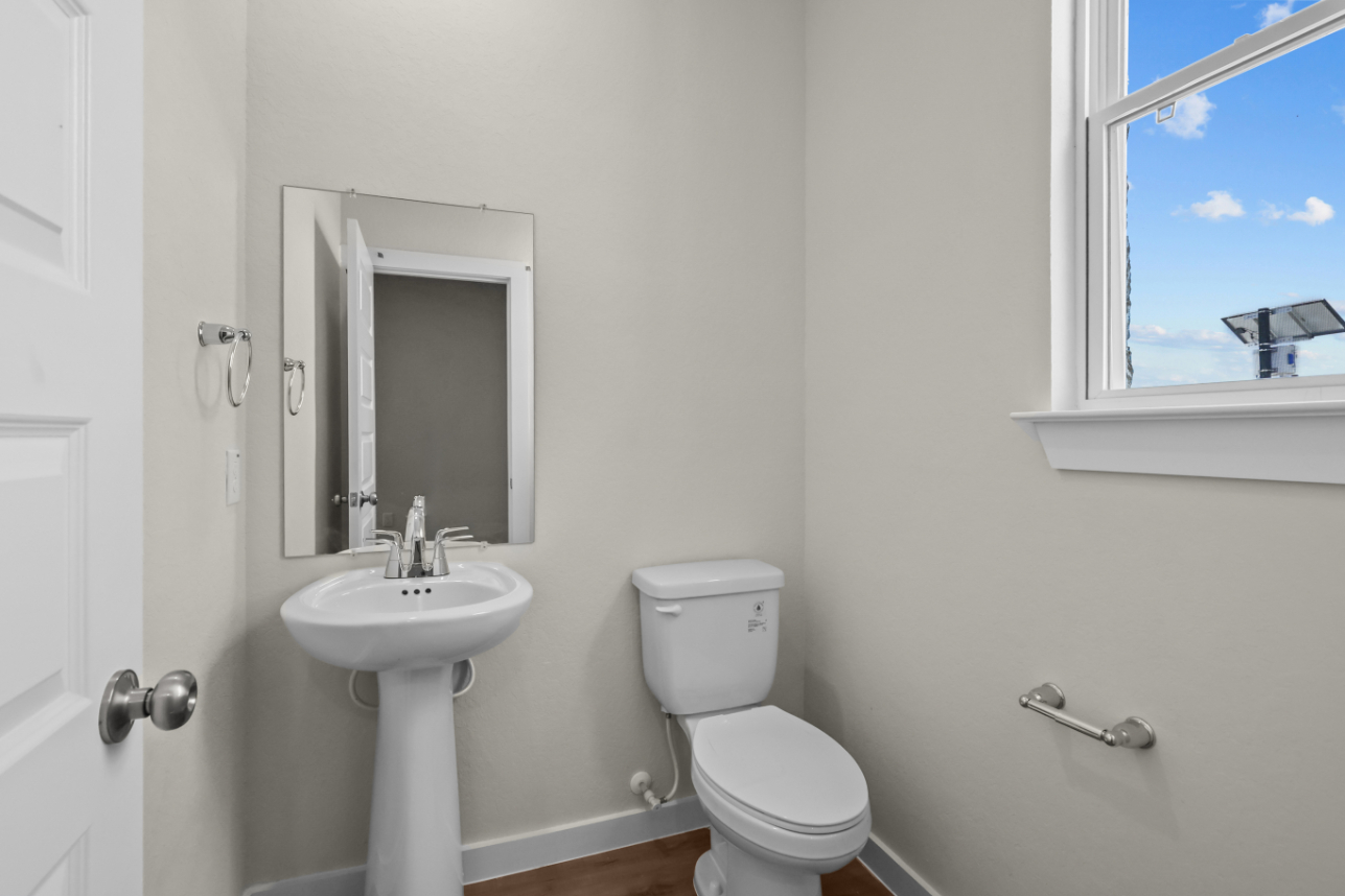A bathroom with a toilet and sink.