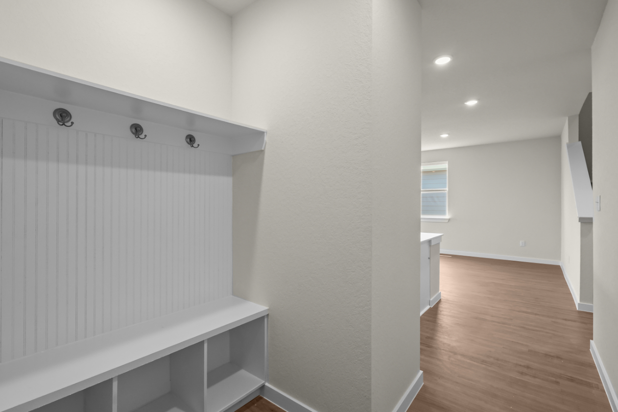 A white room with a wood floor.