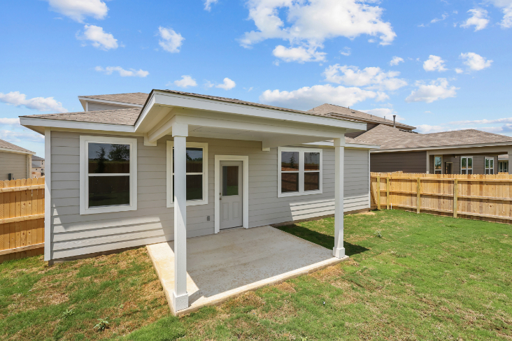 A house with a fence and grass.