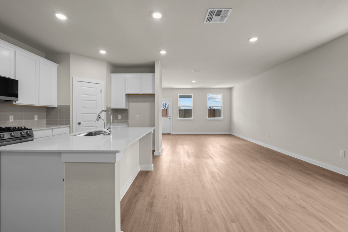 A kitchen with white cabinets.