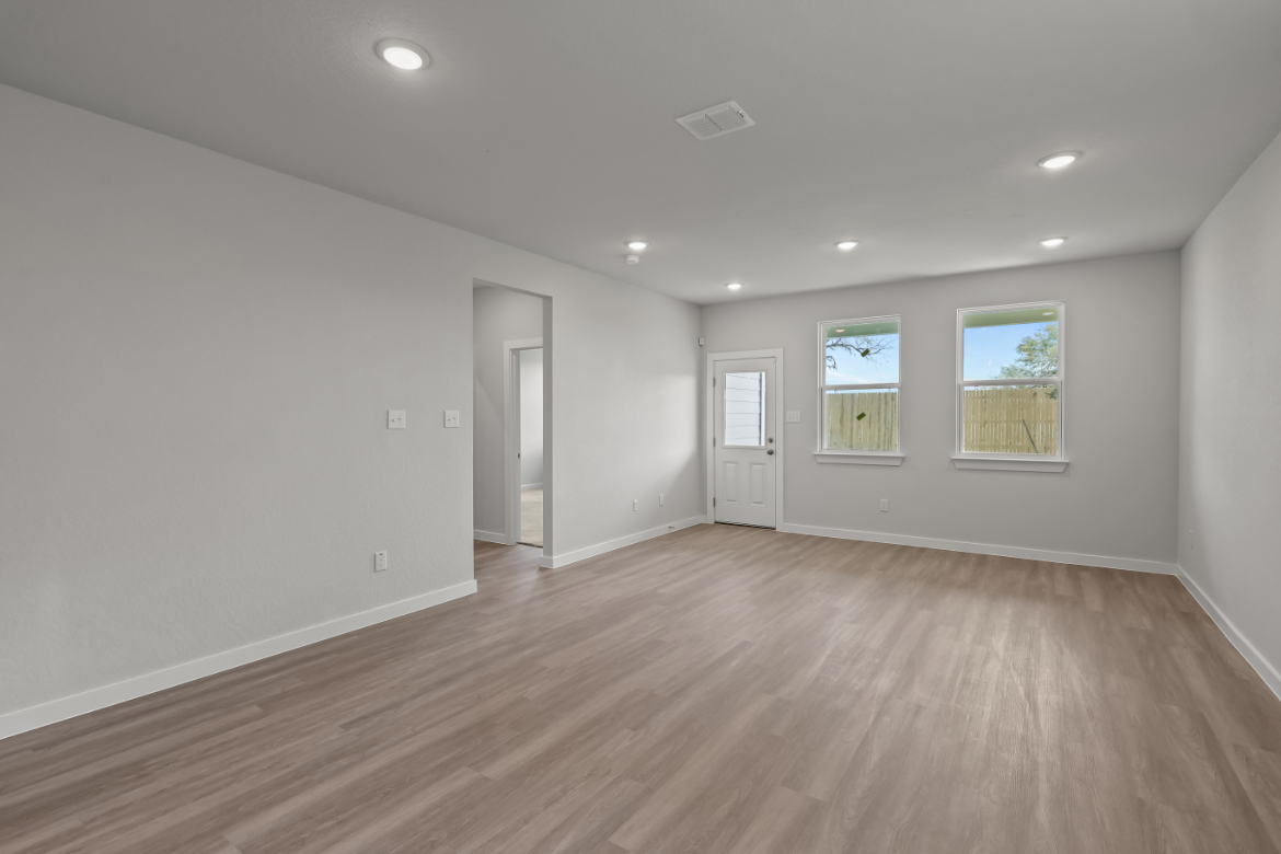 A room with a wood floor and white walls.
