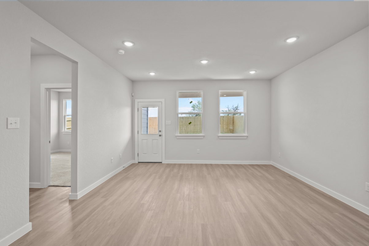 A room with white walls and a wood floor.