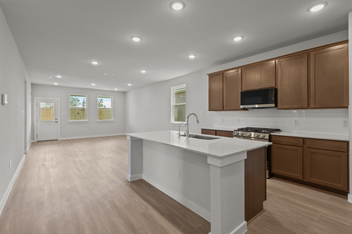 A kitchen with wooden cabinets.