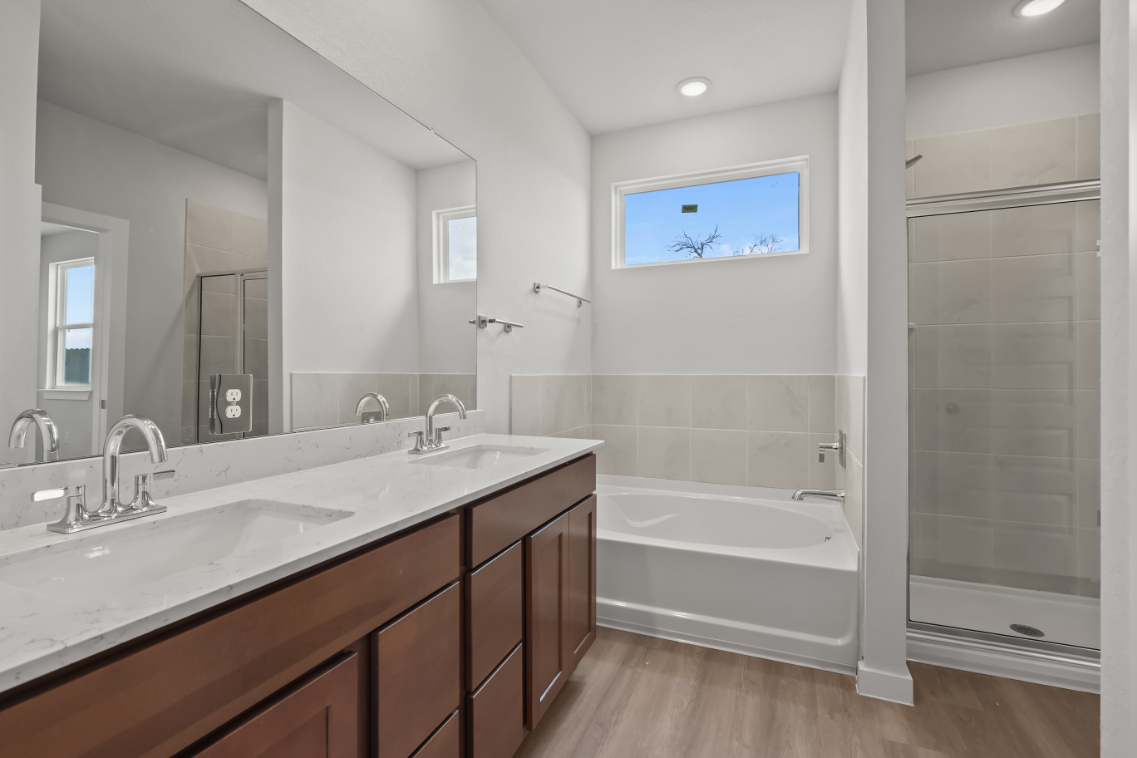 A bathroom with a tub sink and a shower.