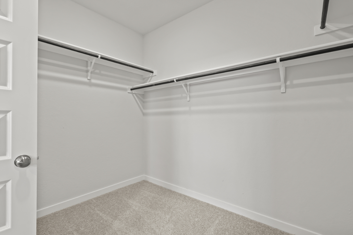 A white wall with a metal railing.