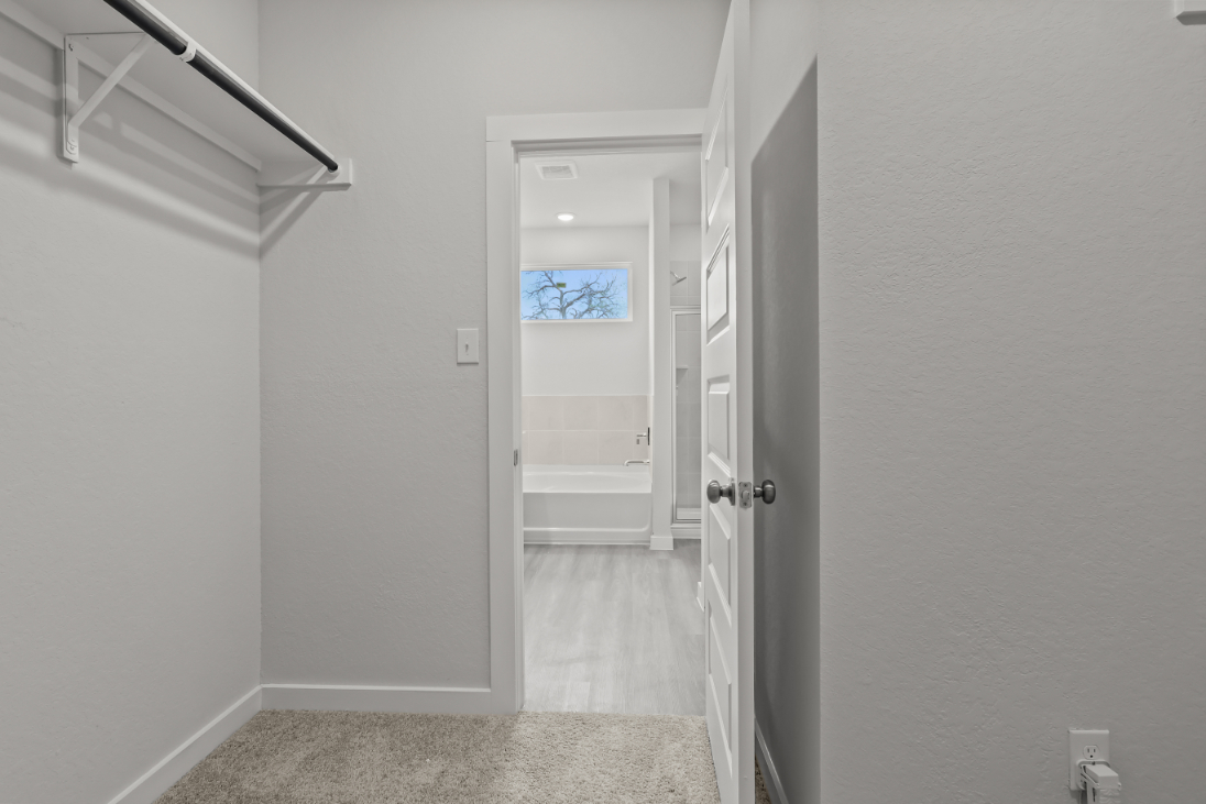 A hallway with white walls.