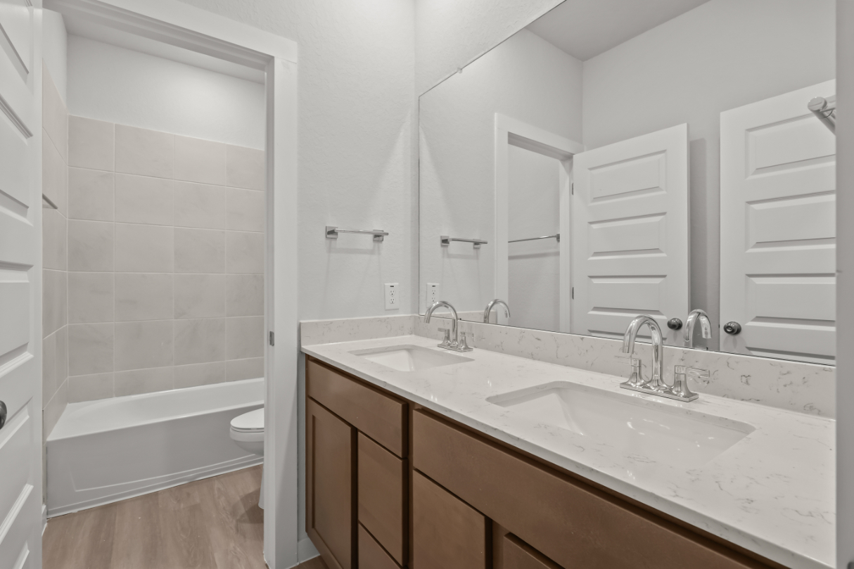 A bathroom with a tub sink and toilet.