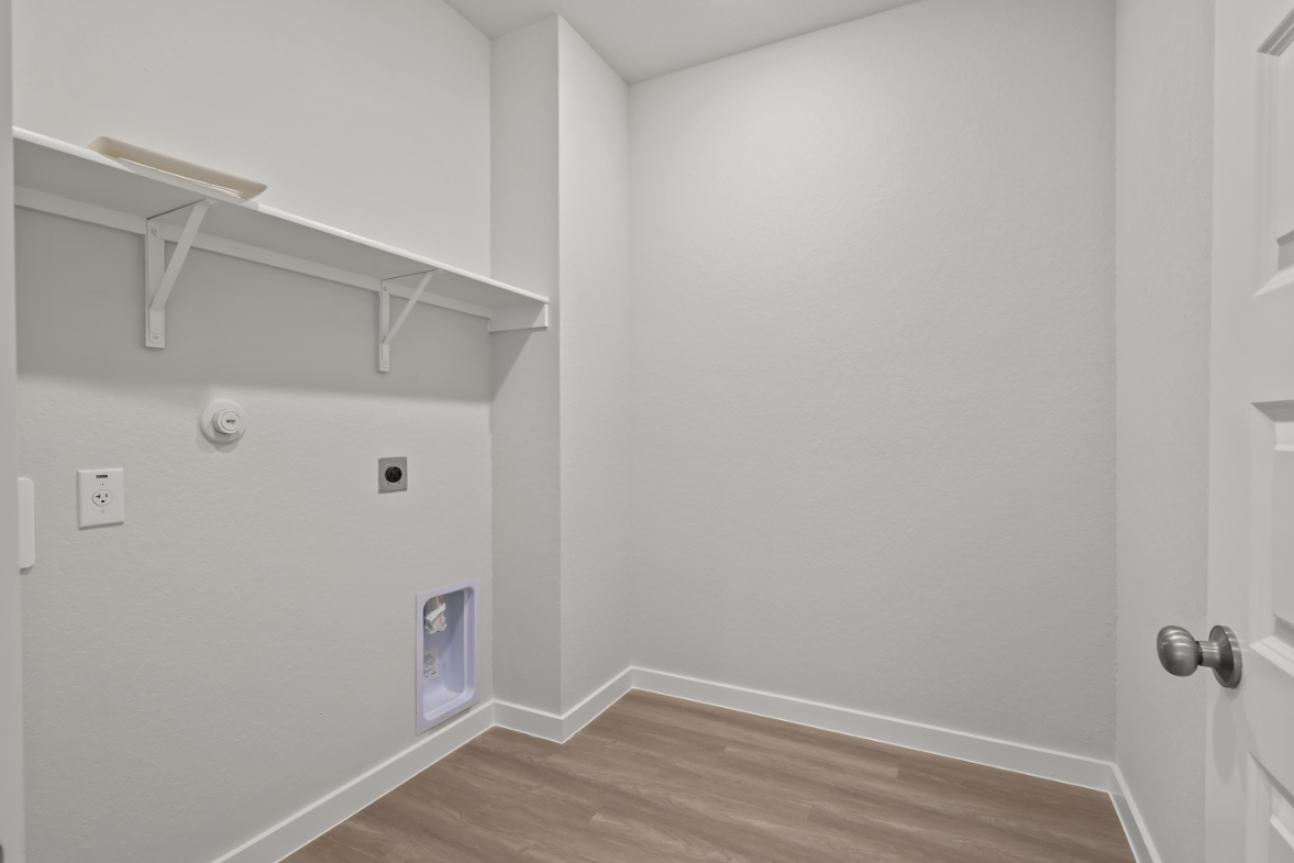 A white room with a wood floor.